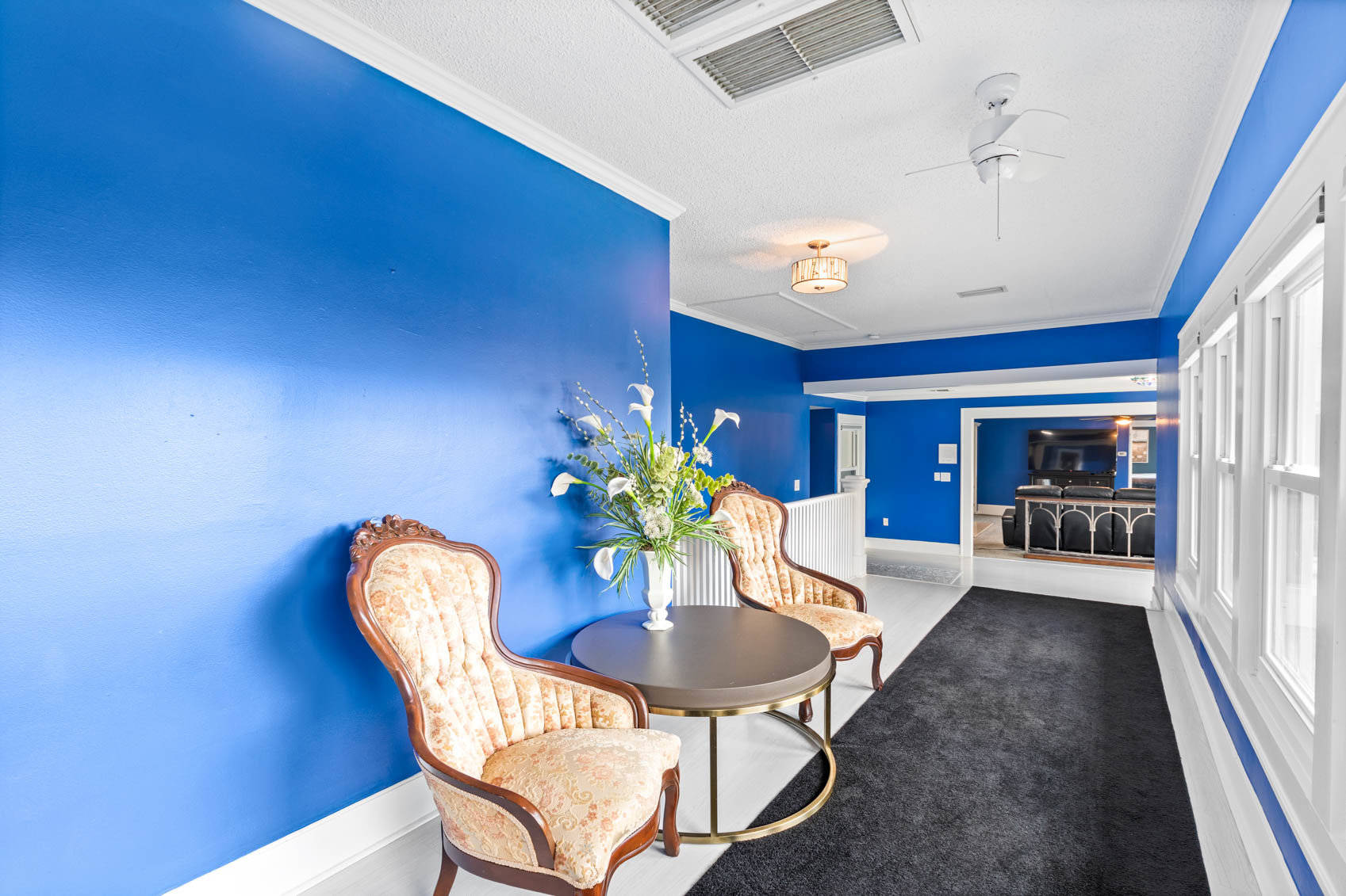 hallway with chairs and bright blue walls
